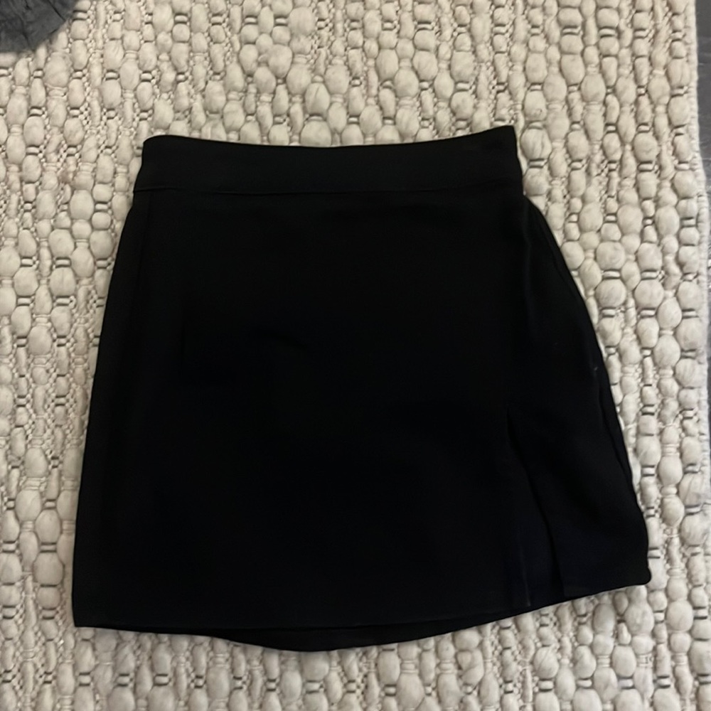 Princess Polly mini skirt with slit.